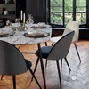 A dining table set with dishes and glasses, next to a window. Podgląd zdjęcia produktu