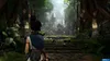 A character stands on a stone path leading to an ancient, overgrown temple. Produktbild-Vorschau