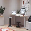 A modern home office setup with an adjustable desk, computers, and stools. Produktbild-Vorschau