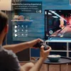 A person is playing a video game on a large TV screen, with text overlays highlighting gaming features. Produktbild-Vorschau