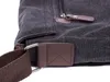 A close-up view of the strap attachment and zipper of a dark gray canvas bag with brown faux leather accents. Podgląd zdjęcia produktu