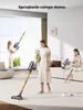 Three women are shown cleaning different areas of a brightly lit, modern living room with cordless vacuum cleaners. Podgląd zdjęcia produktu