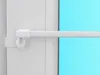 A close-up view of a white curtain rod or tension rod mounted on a white door frame, with a bright blue background visible through a window or glass panel. Produktbild-Vorschau