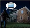 A person dressed in dark clothing, holding a long pole, stands in front of a stone house at night, with a thought bubble above their head containing a television. Produktbild-Vorschau