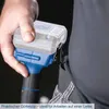 A hand holding a cordless drill with a clip attached to a belt. Produktbild-Vorschau