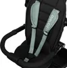 A close-up view of a child's safety harness and stroller bar. Produktbild-Vorschau