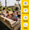 A woman and four children are playing in a wooden sandbox in a garden. Produktbild-Vorschau