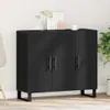 A black wooden sideboard with three doors and metal legs, placed against a white wall with some decorative items on top. Anteprima dell’immagine prodotto
