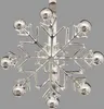 A silver snowflake-shaped napkin ring is shown against a plain gray background. Náhled obrázku produktu