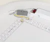 Close-up view of the internal components of an LED ceiling light, including LED strips, a driver, and wiring. Produktbild-Vorschau