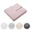 A folded pink blanket is shown against a white background, with smaller circular images of other color options below. Produktbild-Vorschau