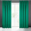 Two teal curtains are drawn open, revealing a window with trees visible outside. The curtains are hanging from a white rod. Produktbild-Vorschau