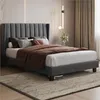 A bedroom scene featuring a dark gray upholstered bed frame with bedding. Podgląd zdjęcia produktu