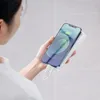 A person is holding a smartphone and a power bank, with cables connecting them. Podgląd zdjęcia produktu
