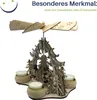 A wooden Christmas pyramid with four tea light holders and decorative figures. Produktbild-Vorschau