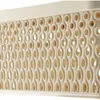 Close-up of a beige plastic storage basket with a patterned, perforated side. Produktbild-Vorschau
