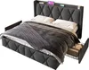 A gray upholstered bed with white bedding and a gray throw blanket is shown against a white background. The bed has a headboard with built-in shelves and a drawer is pulled out from the side, revealing stored items. Podgląd zdjęcia produktu