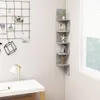 A corner of a room with a desk, a grid on the wall, and a corner shelf unit. Náhľad obrázku produktu