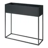 A black metal planter on a stand, shown against a white background. Podgląd zdjęcia produktu