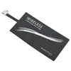 A black wireless charging receiver adapter with white text and graphics, and a silver connector. Produktbild-Vorschau