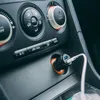 Close-up of a car's center console with a USB car charger plugged in. Náhľad obrázku produktu