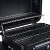 Close-up view of the interior of a black charcoal grill with two silver grill grates. Produktbild-Vorschau