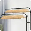 A clothing rack with two tiers of wooden hangers, set against a light gray and white background with vertical blinds. Anteprima dell’immagine prodotto