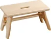 A light-colored wooden step stool with a handle cutout on the top surface, shown against a white background. Náhled obrázku produktu