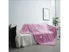 A pink blanket with white stars is draped over a sofa in a living room. Anteprima dell’immagine prodotto