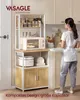 A woman stands in a kitchen next to a multi-tiered kitchen shelf unit. Produktbild-Vorschau