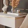 A close-up of a modern bedside table with decorative items. Produktbild-Vorschau