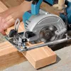 A person is using a cordless circular saw to cut a piece of wood. Produktbild-Vorschau