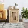 A dog crate designed to look like a piece of furniture, placed next to a sofa and a plant. Náhled obrázku produktu