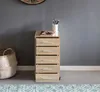 A roll container with drawers next to a basket, against a gray wall. Produktbild-Vorschau