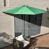 A green half-umbrella is set up on a wooden deck next to a sliding glass door. A brown armchair with a white cushion is placed on the deck. Anteprima dell’immagine prodotto