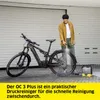 A man is cleaning an electric bike with a pressure washer in front of a garage. Náhled obrázku produktu