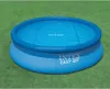 An inflatable pool with a solar cover on a grassy lawn. Voir les images du produit
