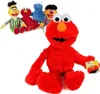 A group of Sesame Street plush toys are displayed against a white background, with one large Elmo plush in the foreground. Produktbild-Vorschau