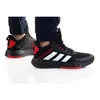 A pair of Adidas sneakers worn by a person, shown from a side angle against a white background. Podgląd zdjęcia produktu