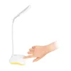 A hand is shown pressing the power button on a desk lamp. Produktbild-Vorschau