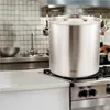 A large stainless steel pot with a lid sits on a gas stove in a kitchen. Produktbild-Vorschau
