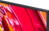 A close-up view of the corner of a television screen displaying a colorful abstract image. Voir les images du produit