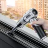 A hand is holding a portable vacuum cleaner and cleaning a window track. Produktbild-Vorschau