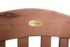 A close-up of a wooden bench with a brass plaque. Produktbild-Vorschau