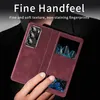 A person's hand is holding a red phone case with a view window, showcasing the phone inside. Produktbild-Vorschau