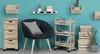 A collection of wooden storage units and a chair against a teal wall. Náhled obrázku produktu