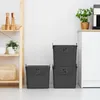 A set of three gray trash bins are stacked and placed next to a white cabinet in a kitchen setting. A plant is on top of the cabinet. Produktbild-Vorschau
