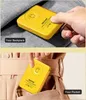 A yellow wireless charger is shown being placed into a backpack and then into a pocket. Voir les images du produit