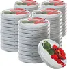 Several stacks of round lids with strawberry and leaf designs, with one lid in the foreground showing a close-up of the design. Podgląd zdjęcia produktu