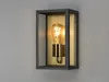 A wall-mounted light fixture with a clear glass enclosure and a brass-colored socket holding a vintage-style light bulb. Produktbild-Vorschau